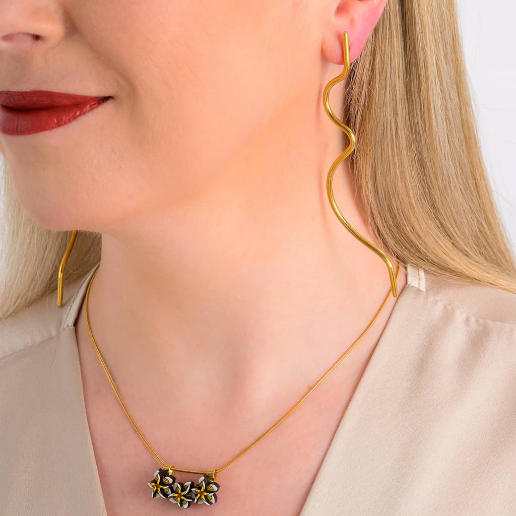 Wimbi recycled brass statement earrings worn by a model